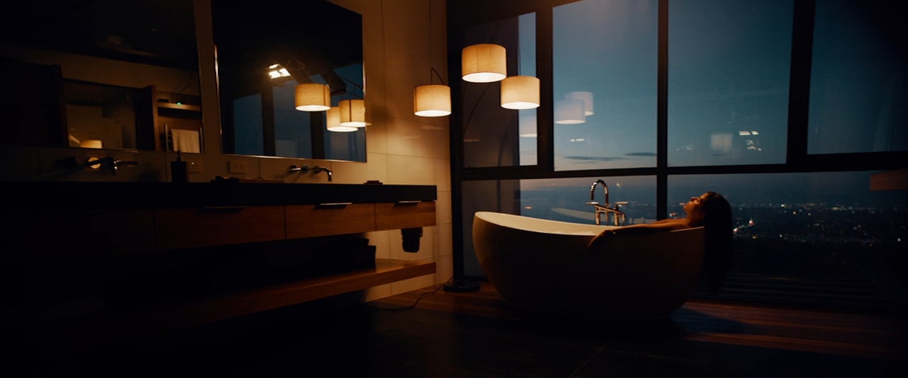 Woman relaxing in a bathtub overlooking the city in the Particle Turn Life Back On brand film