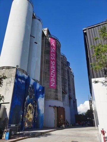 The exterior of The Silos, the branded silos against a blue sky