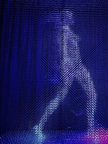 A human figure rendered in a wall of blue light