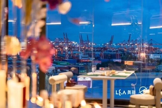 The venue interior with the Shekou container port through the windows